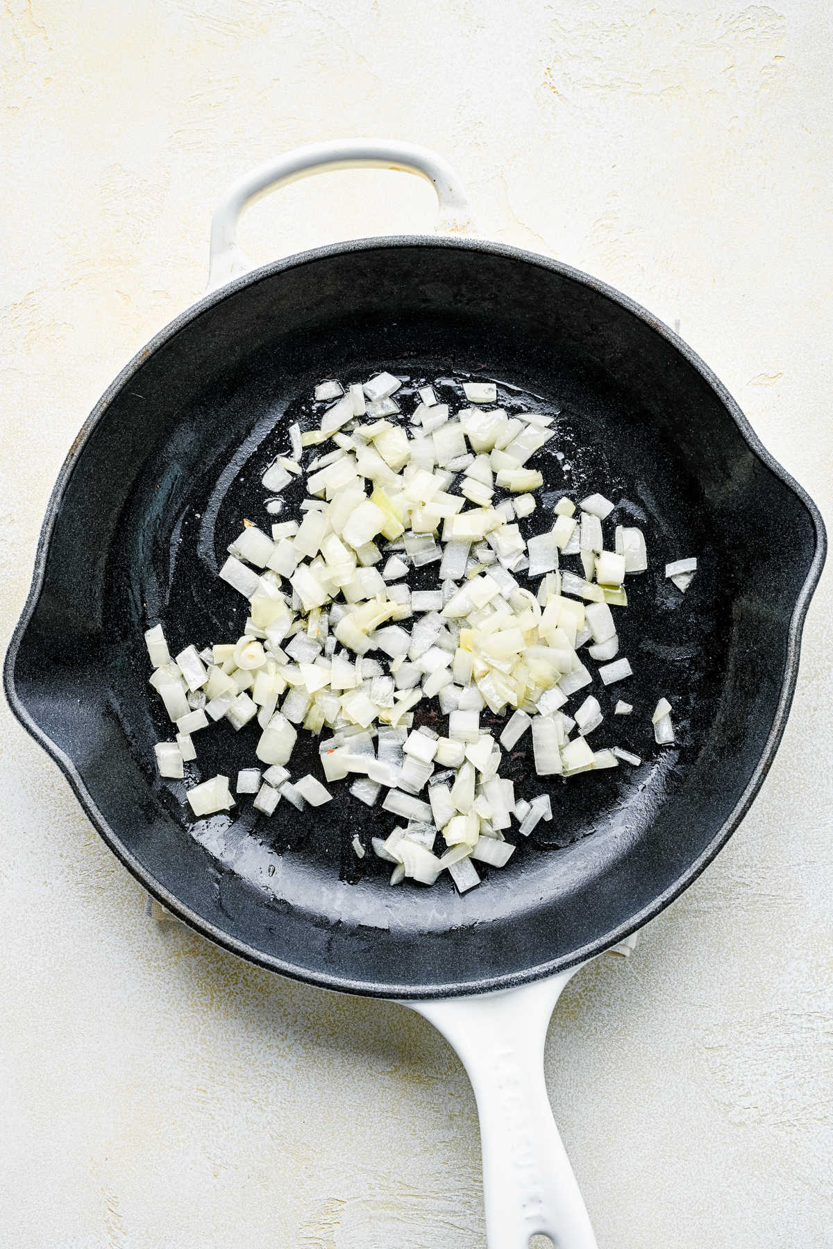 Diced onion in butter in a cast iron skillet.