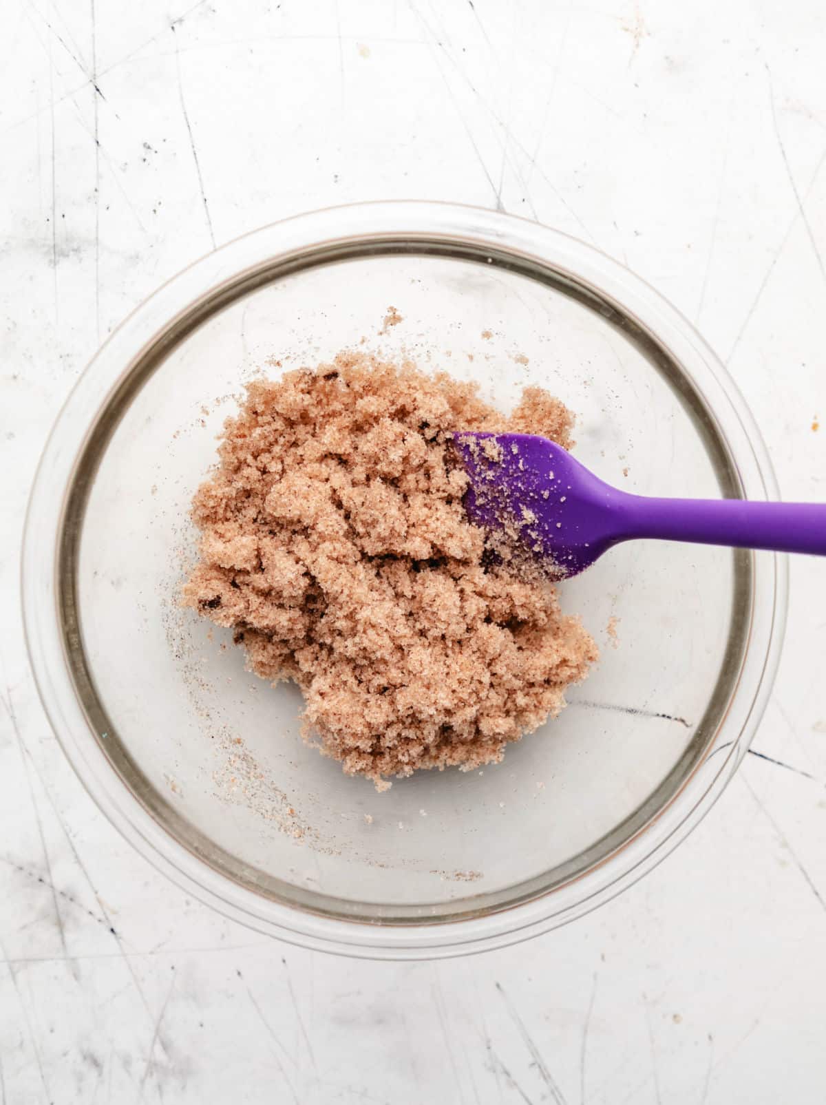 Cinnamon sugar topping a glass mixing bowl. 