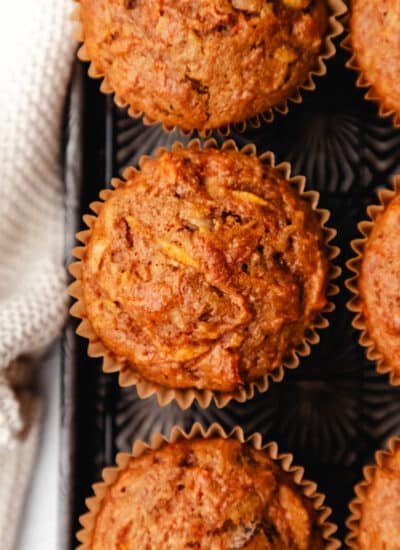 Close up photo of morning glory muffins on a vintage baking sheet.