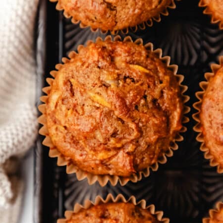 Close up photo of morning glory muffins on a vintage baking sheet.