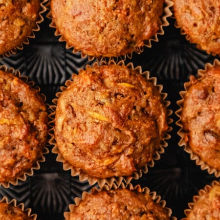 Morning glory muffins in rows on a vintage baking sheet.