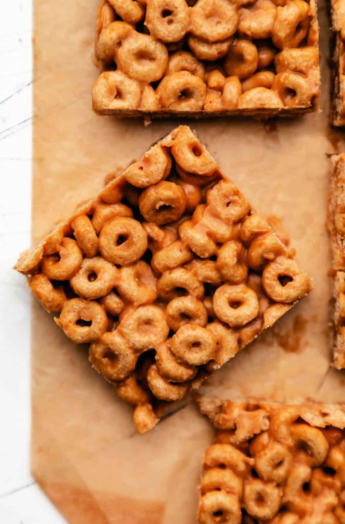 A peanut butter cheerio bar at an angle next to other cheerio bars. 