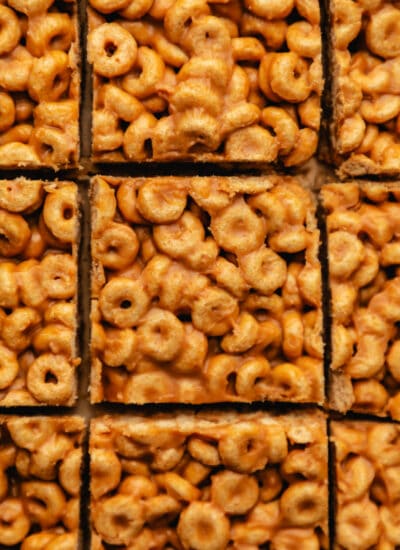 Close up photo of peanut butter cheerio bars cut into pieces.