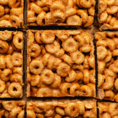 Close up photo of peanut butter cheerio bars cut into pieces.