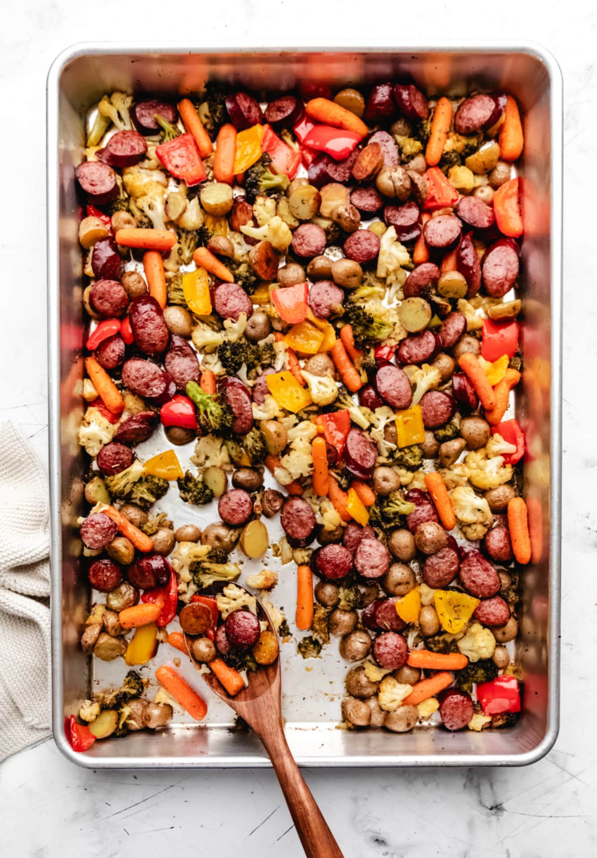 A sheet pan full of sausage and veggies.
