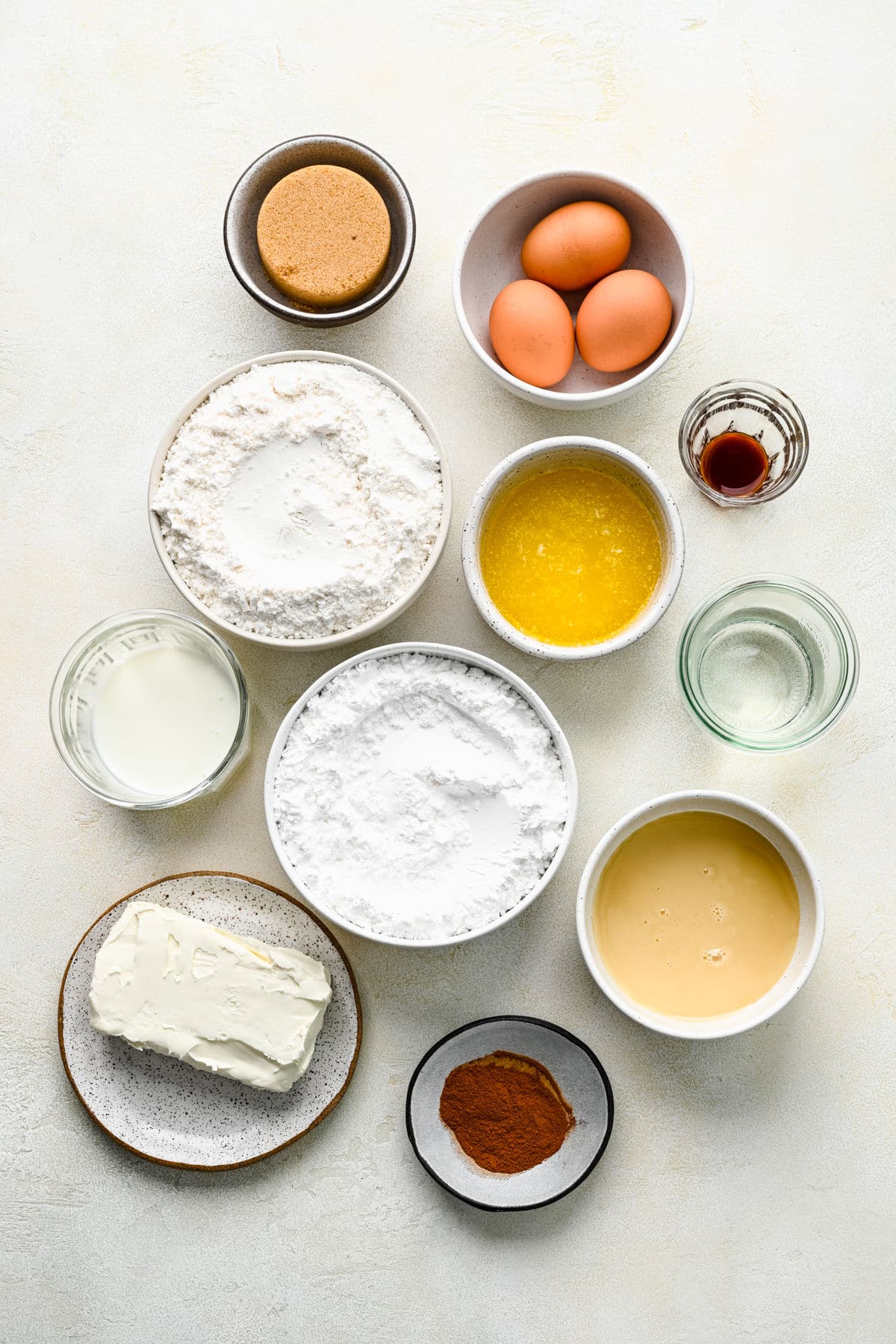 Ingredients for cinnamon roll poke cake in dishes. 