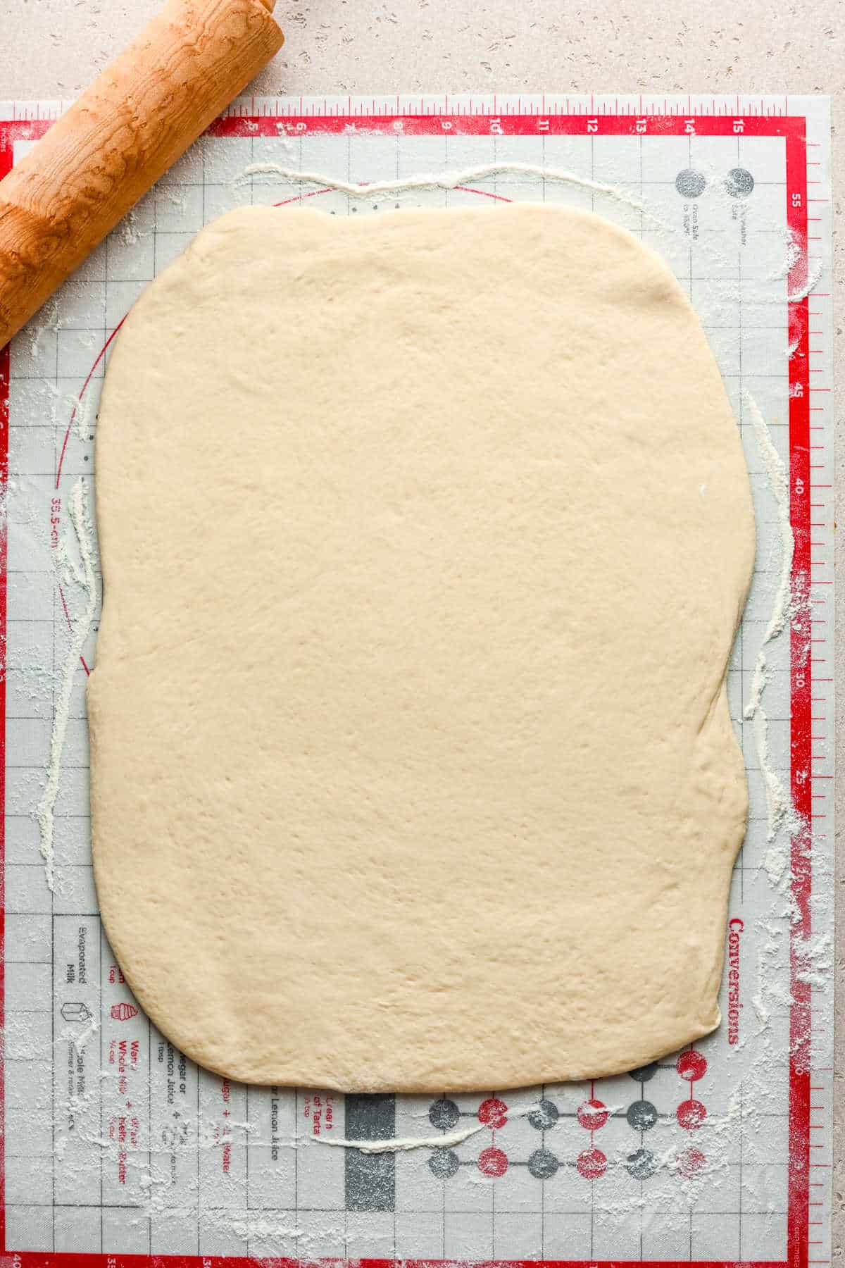 Cinnamon breadstick dough rolled out into a rectangle. 