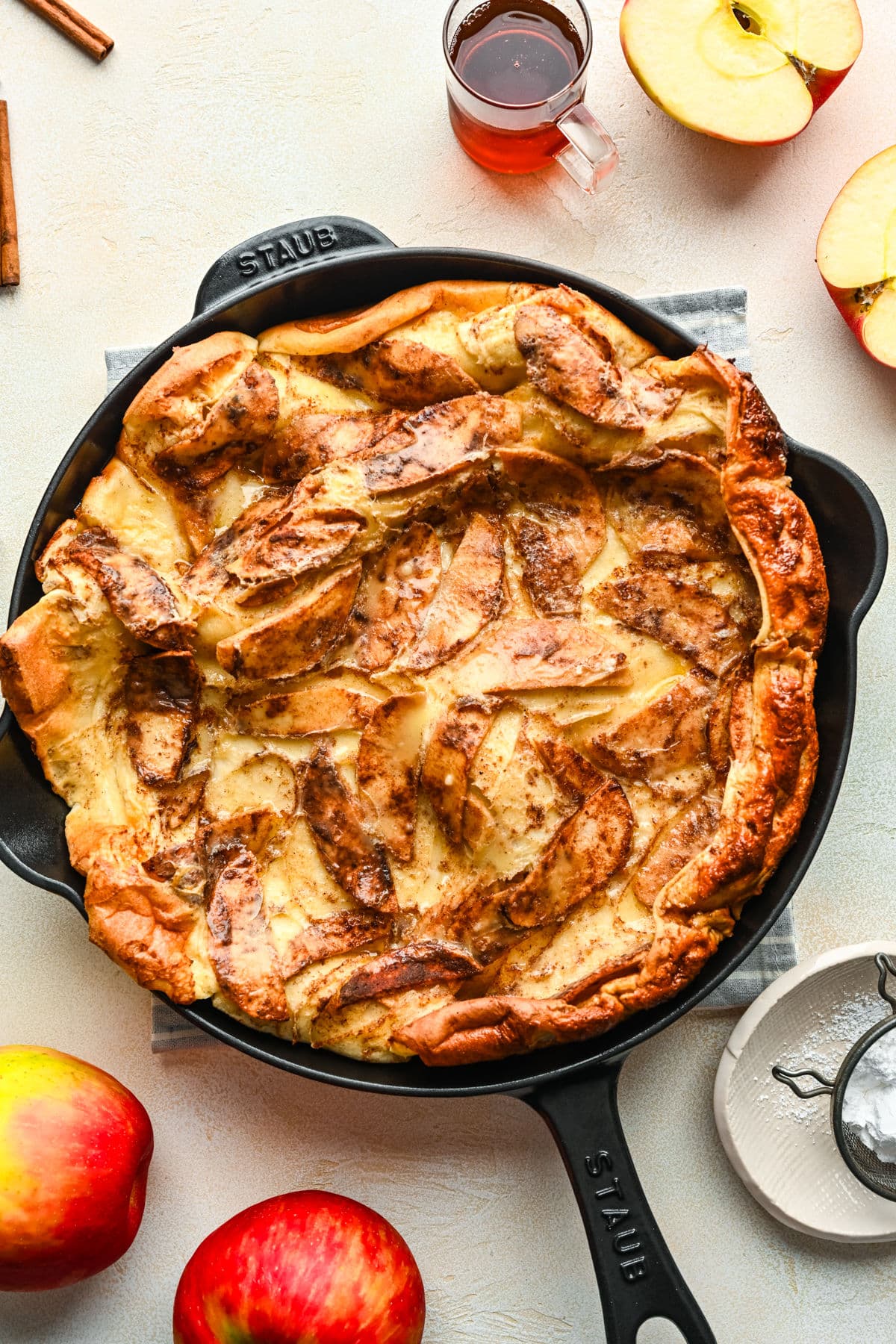 Baked German apple pancake in a cast iron skillet.