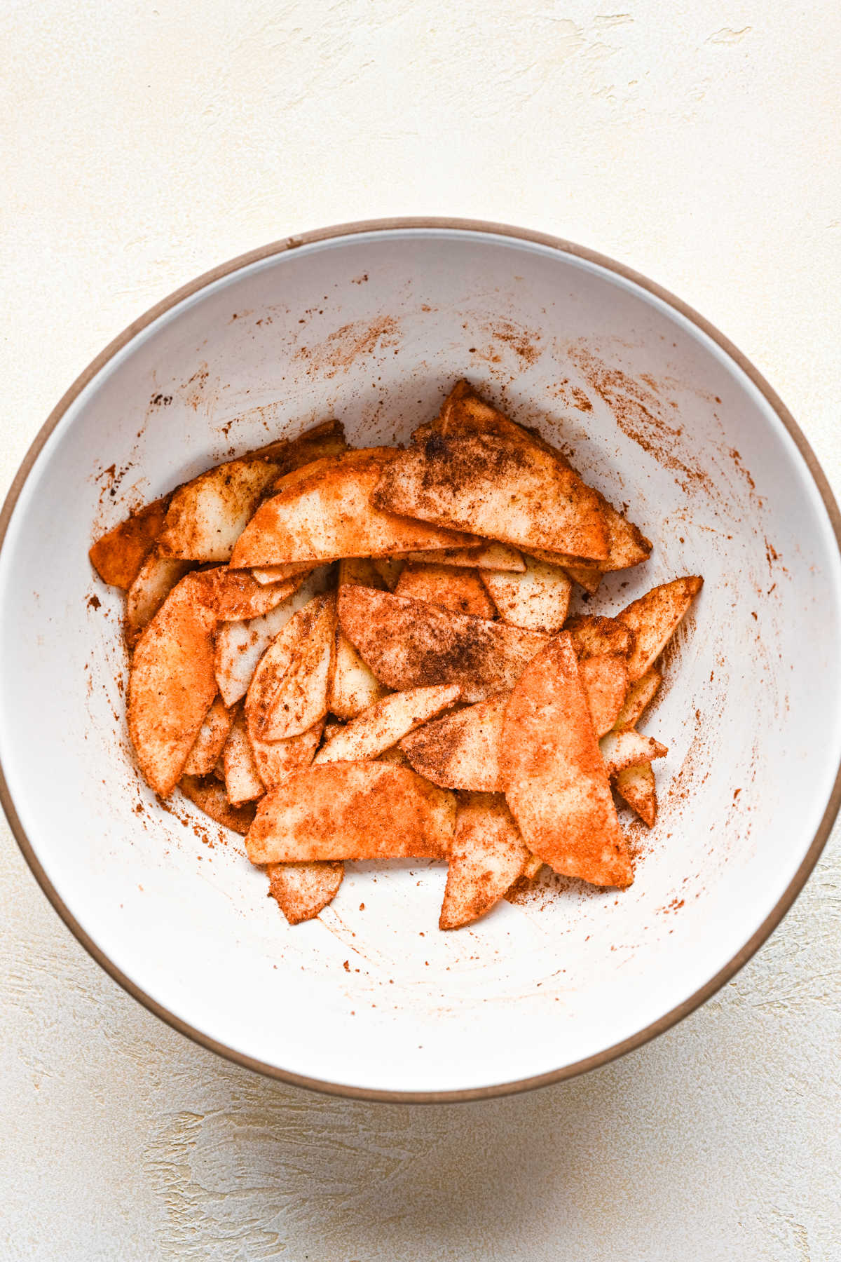 Apples in cinnamon spice mixture for German apple pancake.