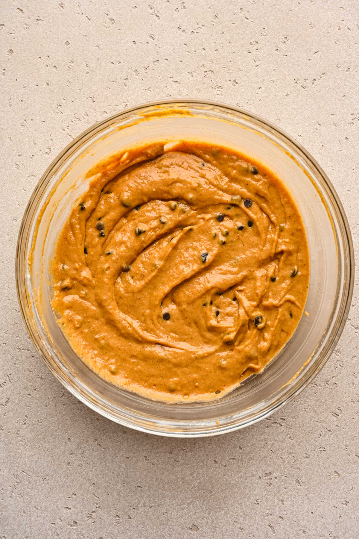 Chocolate chips stirred into pumpkin muffin batter.