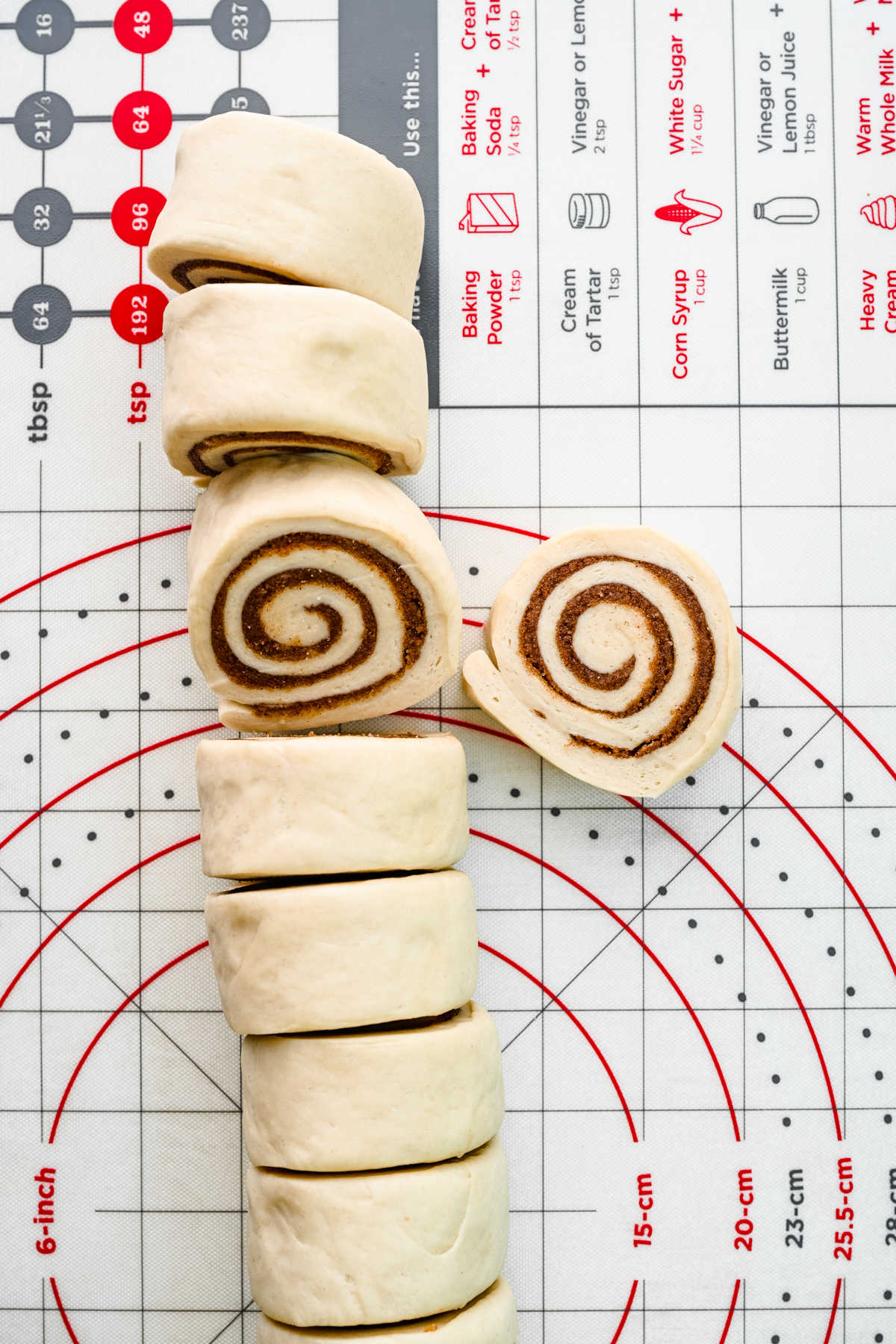 Filled sticky bun dough rolled up and cut into pieces. 