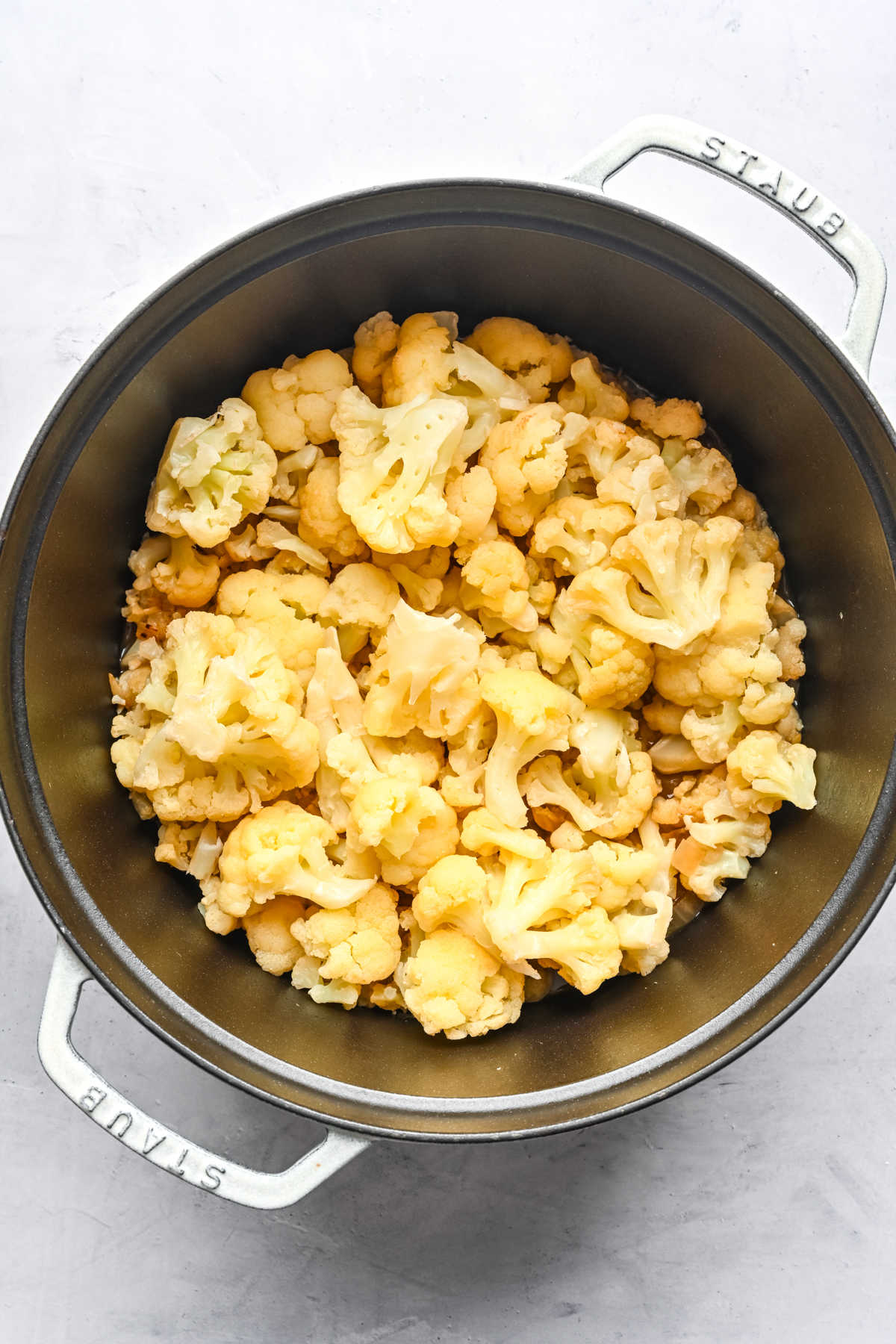 Cauliflower in a pot of broth.