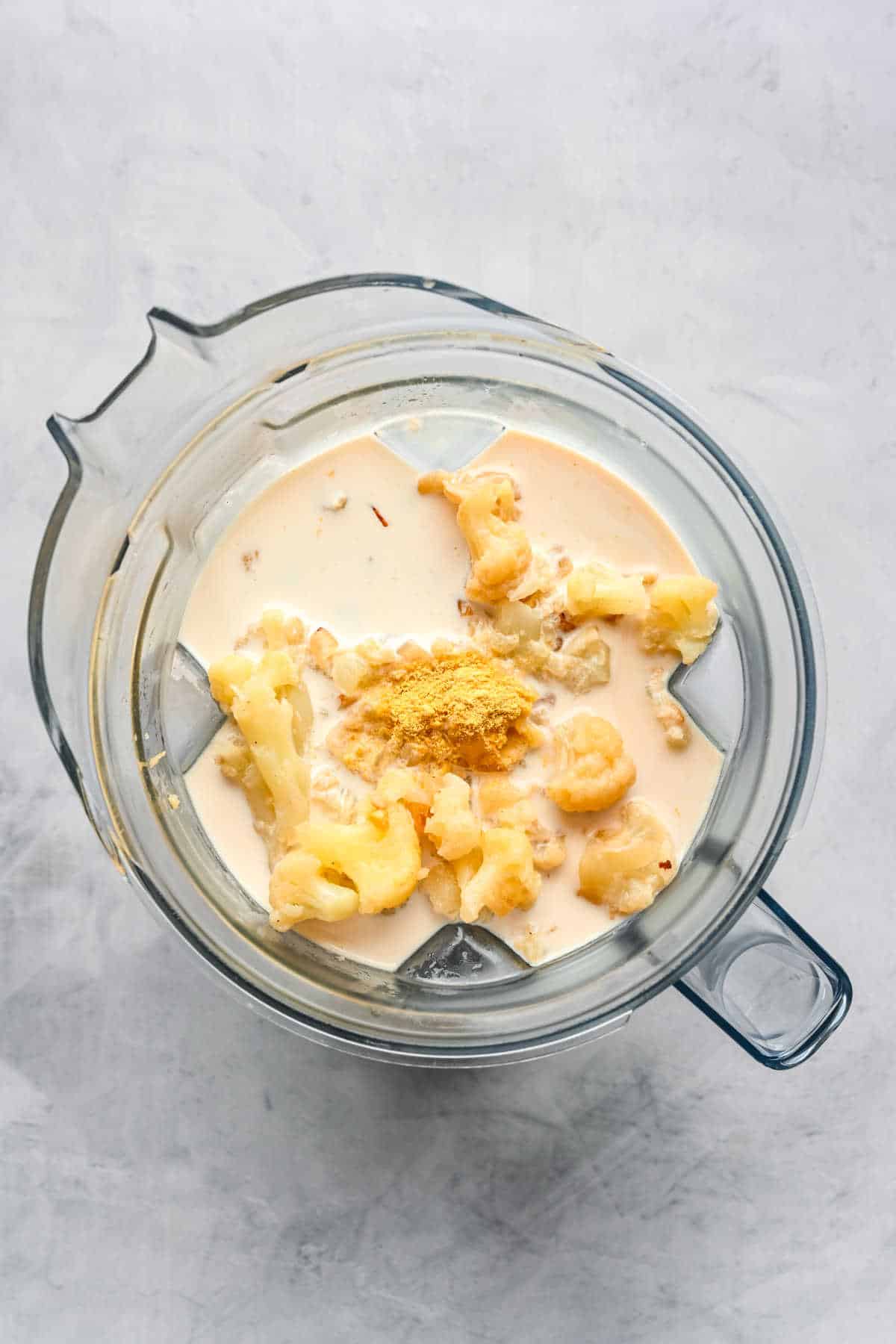 Steamed cauliflower and half and half in a blender. 