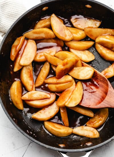 Sauteed cinnamon apples in a cast iron skillet.