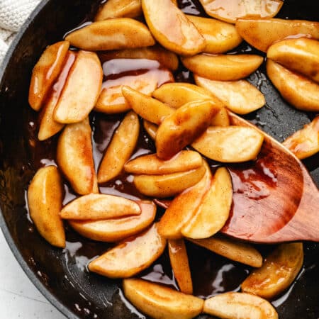 Sauteed cinnamon apples in a cast iron skillet.