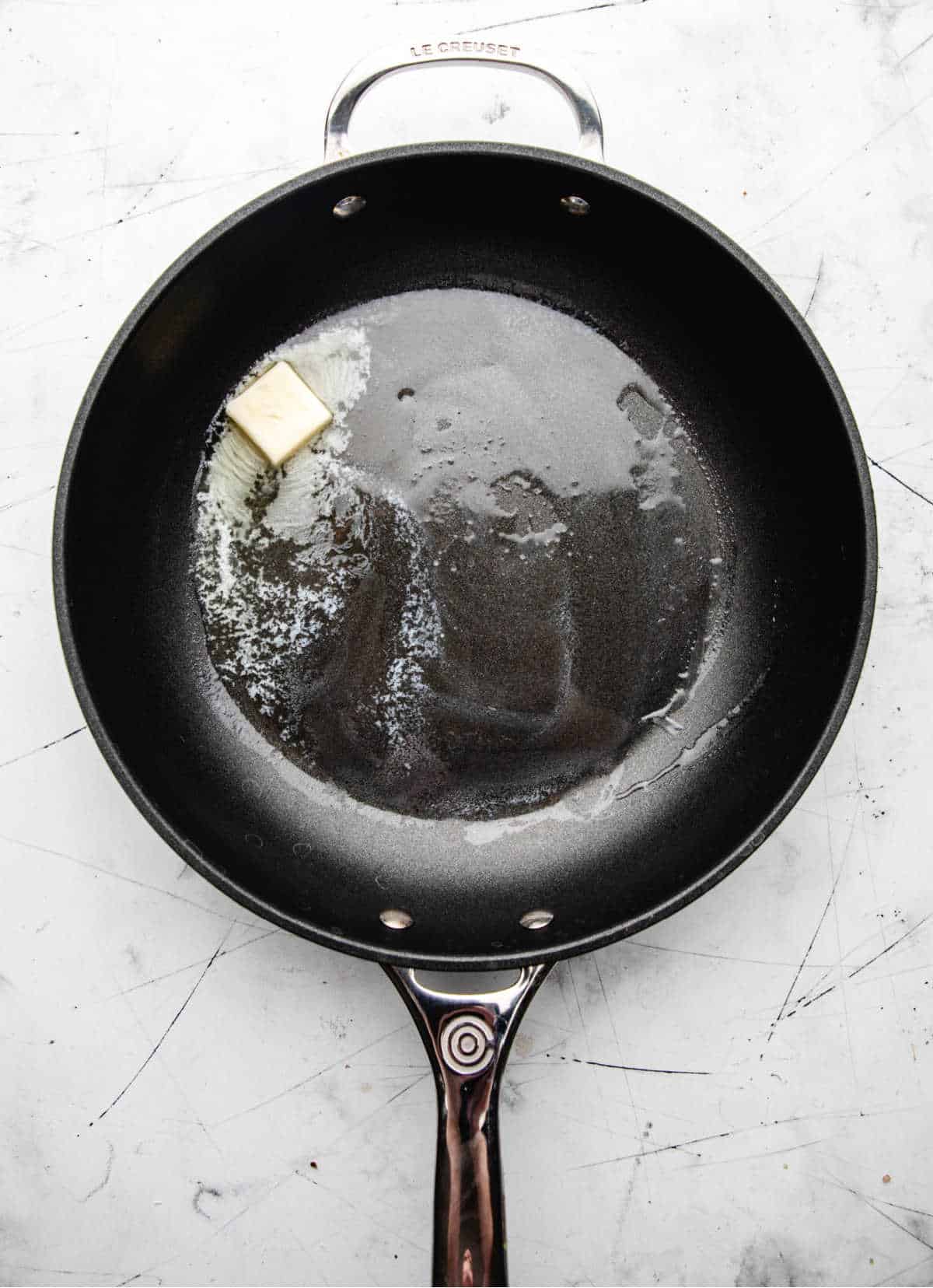 Butter melting in a cast iron skillet. 