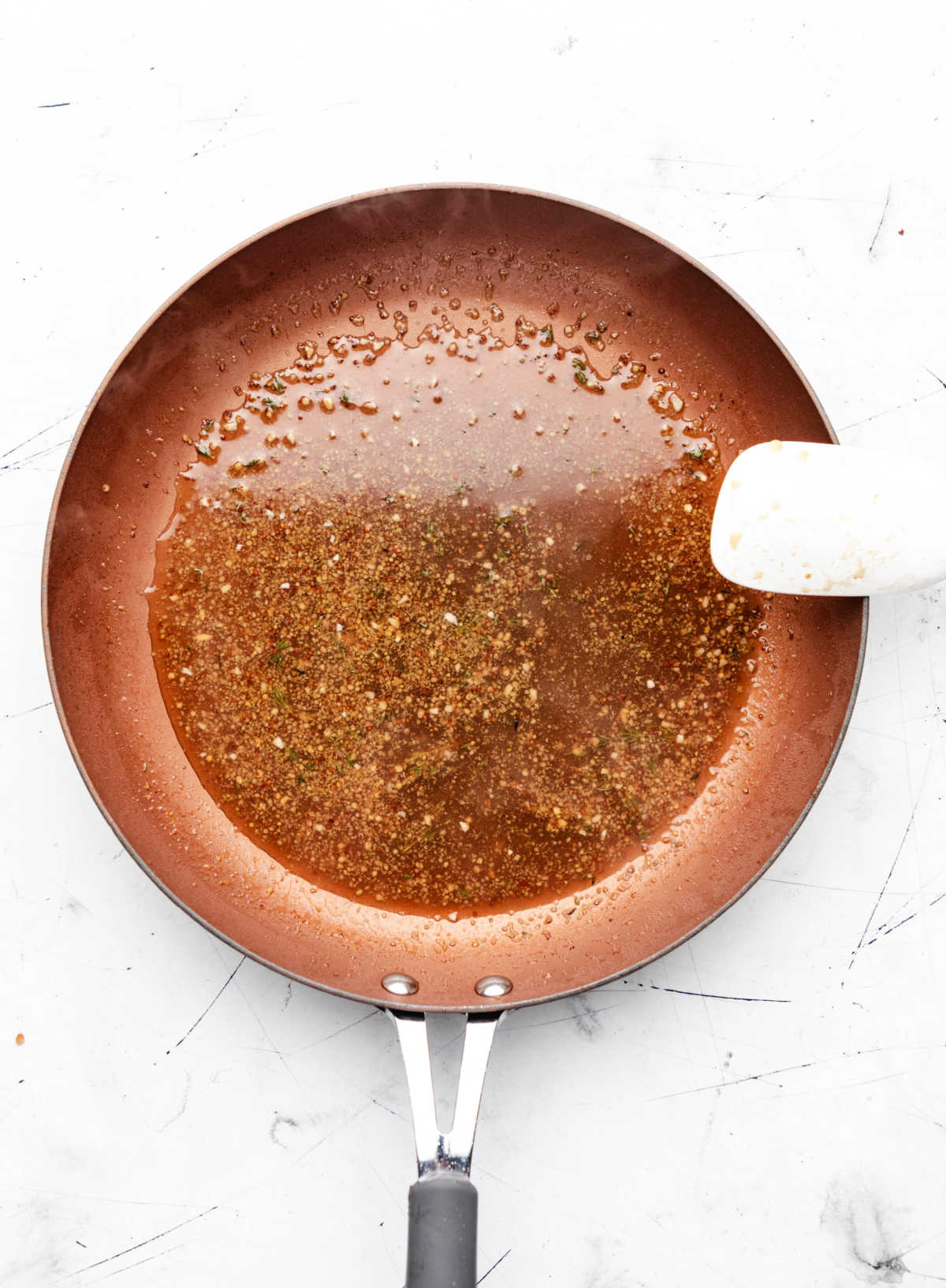 Reduced maple mustard sauce in a copper skillet.