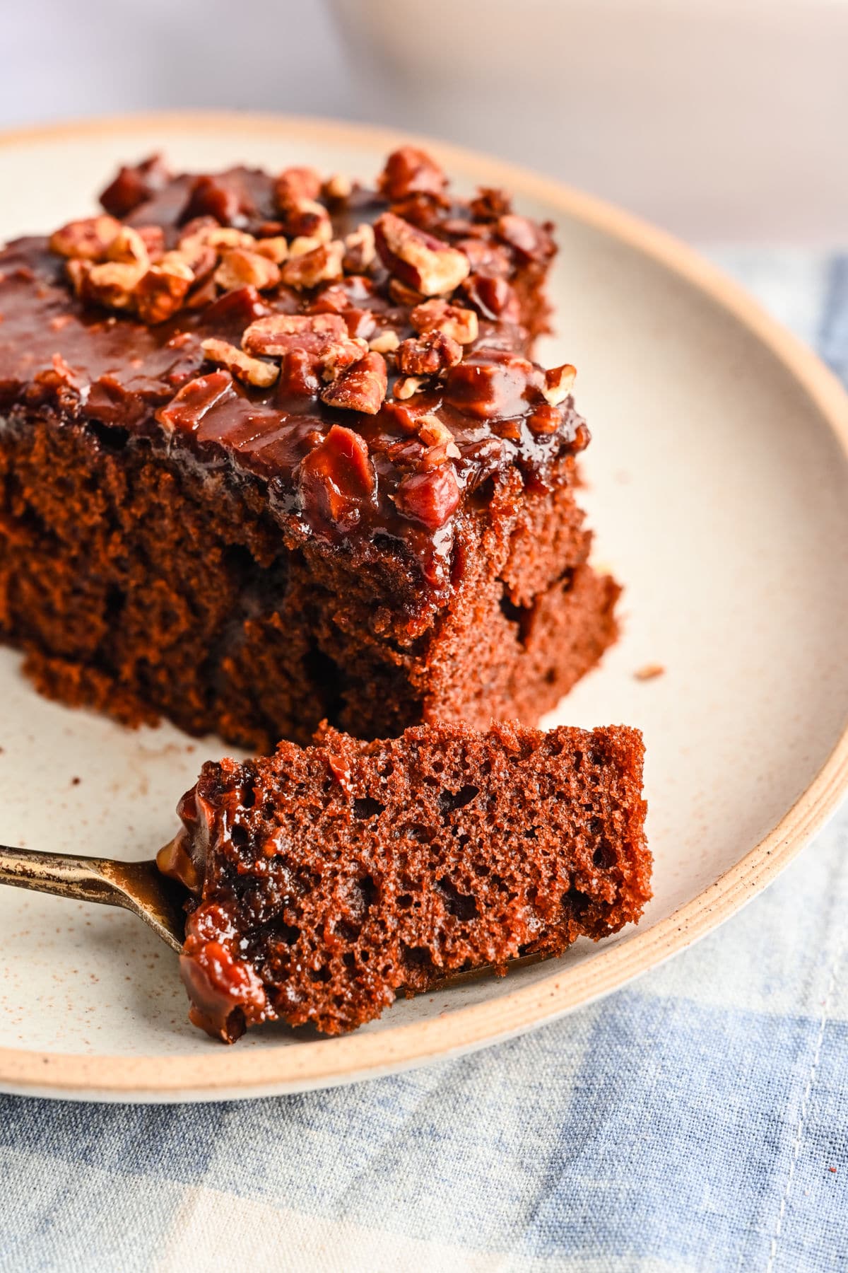 A bite of coca cola cake on a fork.