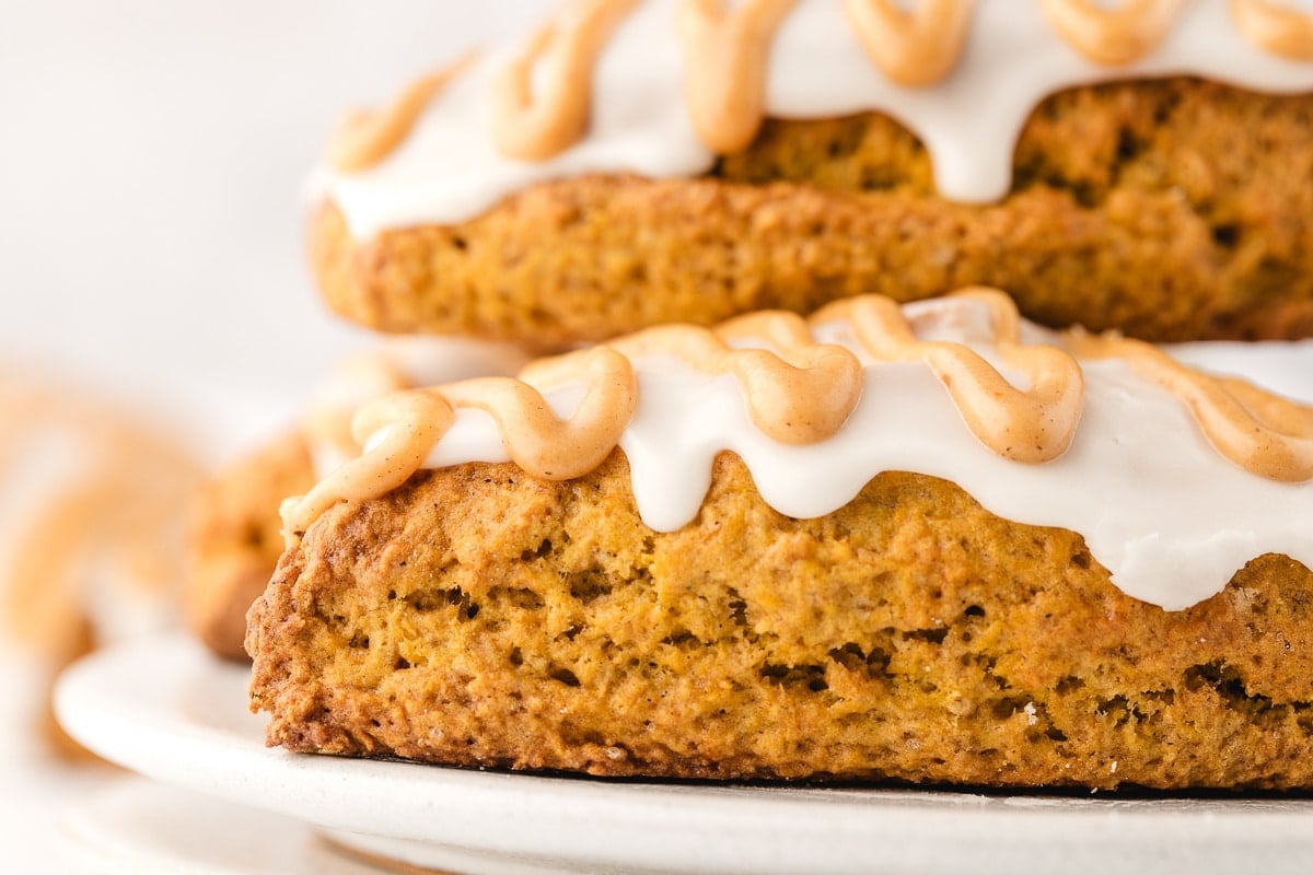 A closeup photo of two pumpkin scones on top of each other.