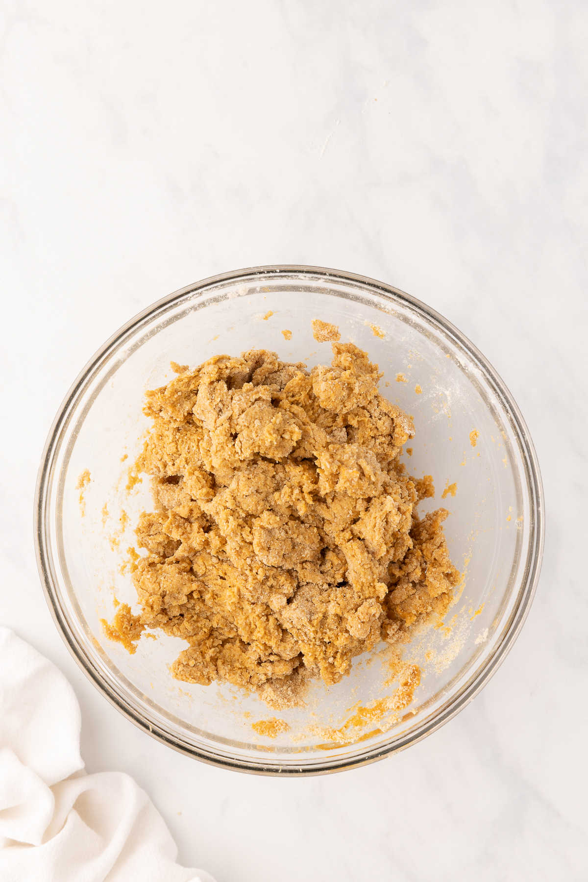 Pumpkin scone dough in a glass mixing bowl. 