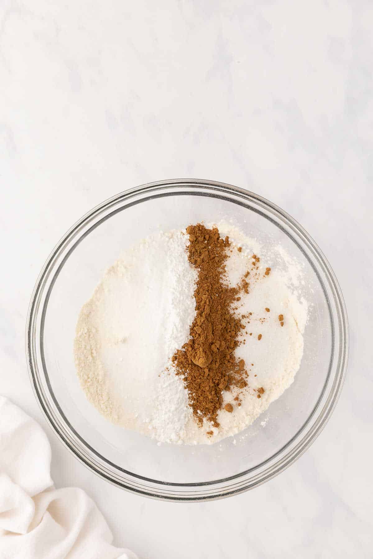 Dry ingredients for pumpkin scones in a glass mixing bowl. 