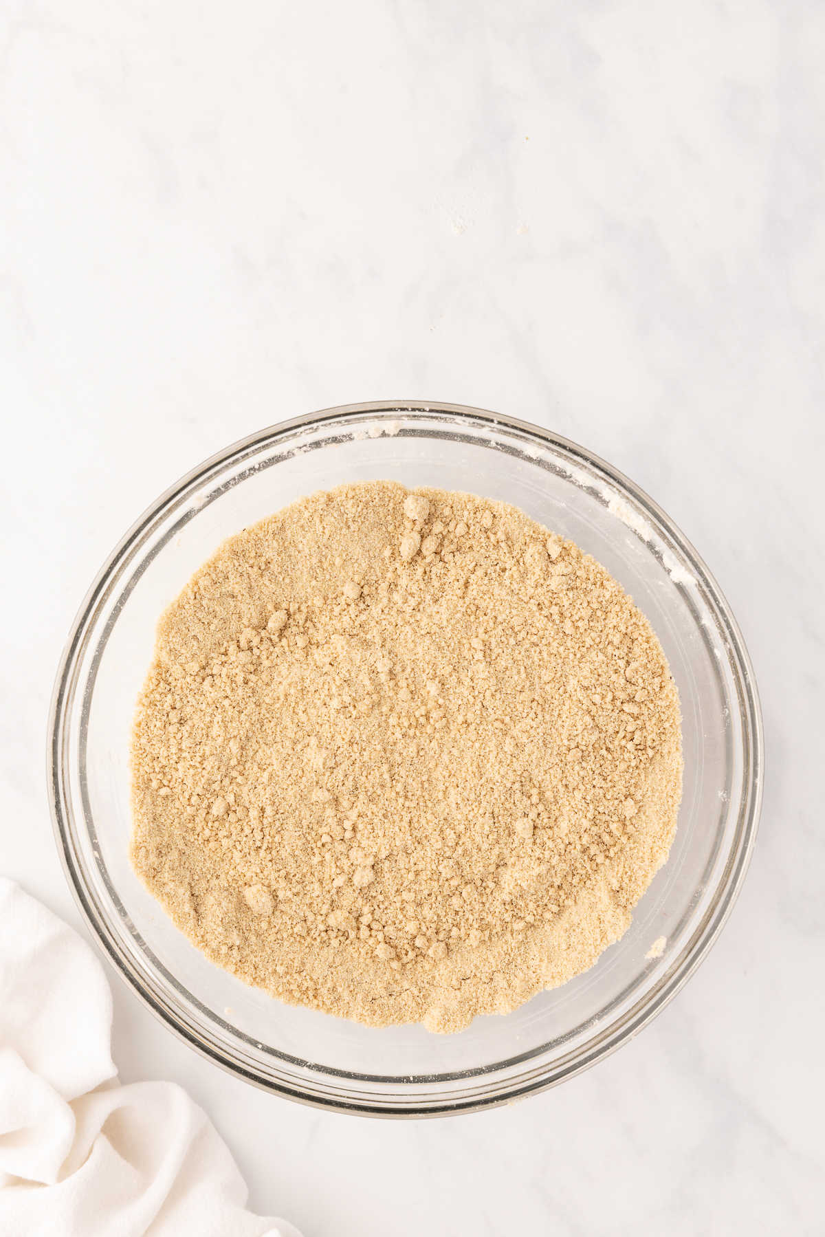 Butter cut into dry ingredients in a glass mixing bowl. 