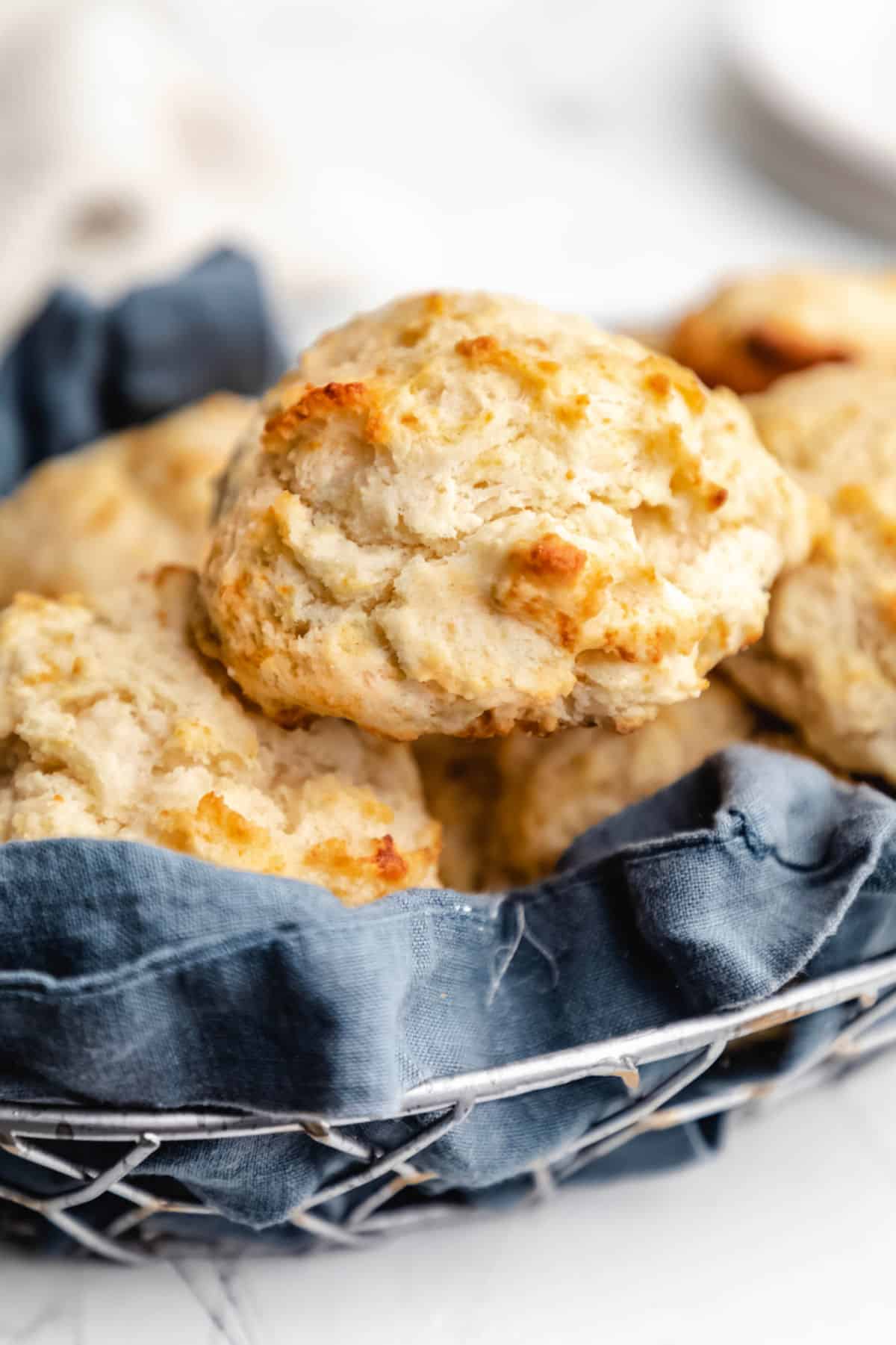 Buttermilk biscuit on top of a stack of other buttermilk biscuits.