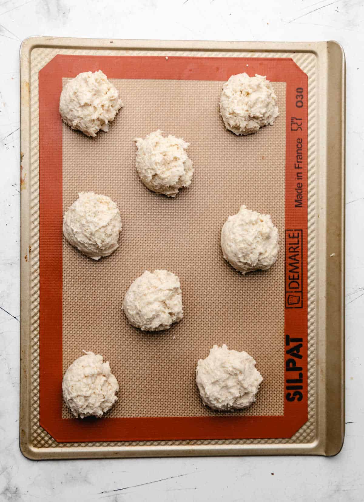 Biscuit batter on a baking sheet. 