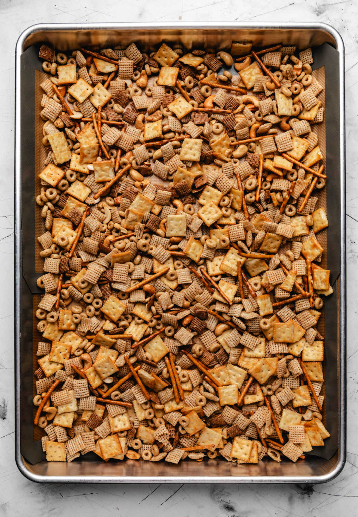A tray of unbaked Chex Mix.