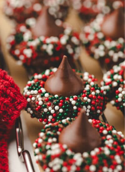 A row of Christmas kiss cookies on a wire cooling rack.