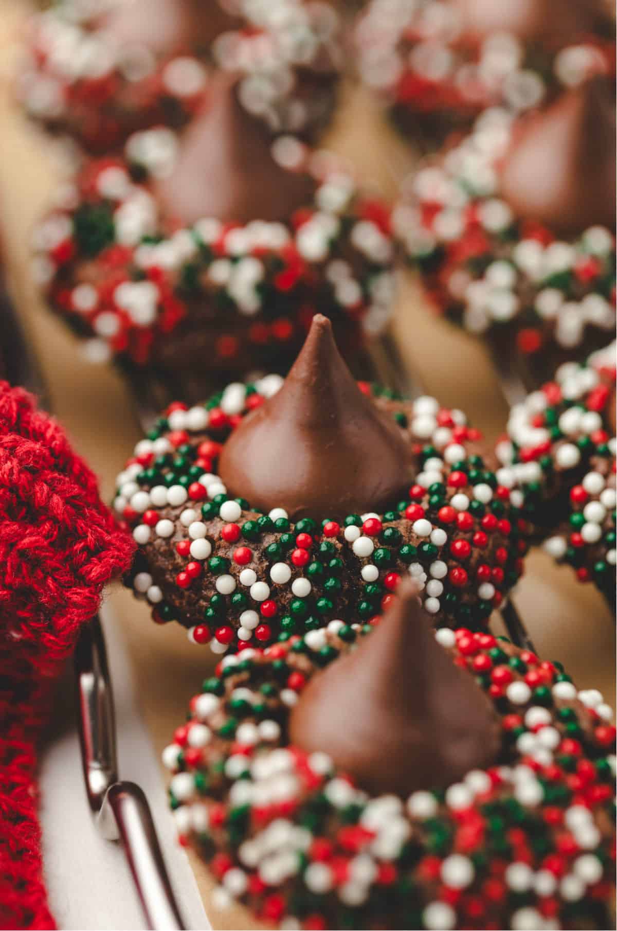 A row of Christmas kiss cookies on a wire cooling rack.