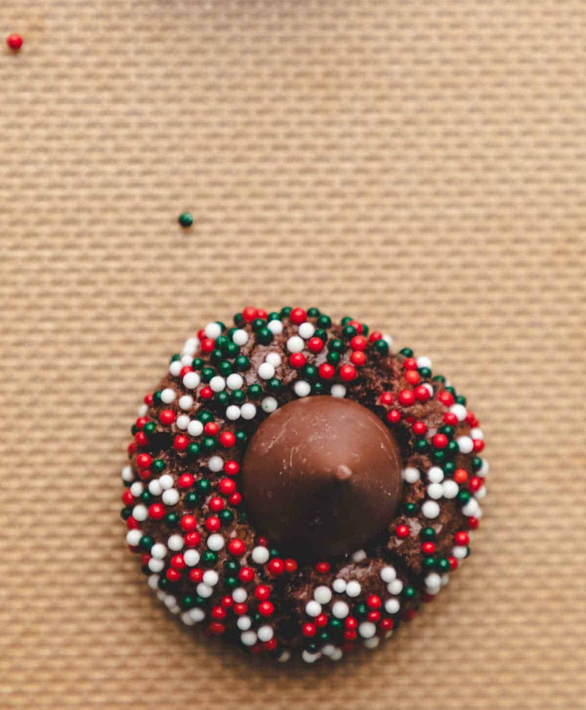 A kiss on top of a Christmas kiss cookie.