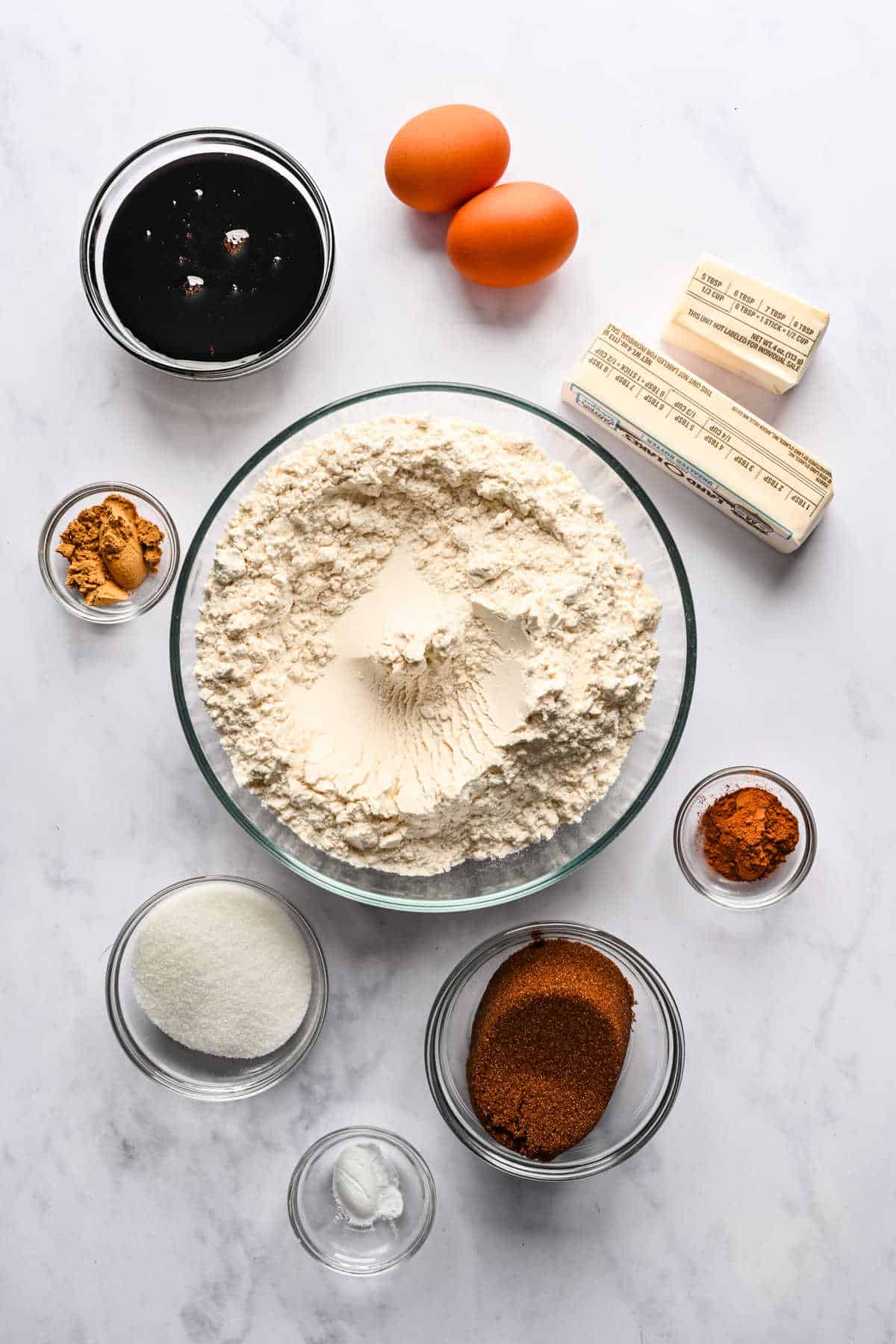 Ingredients for gingerbread men in dishes.