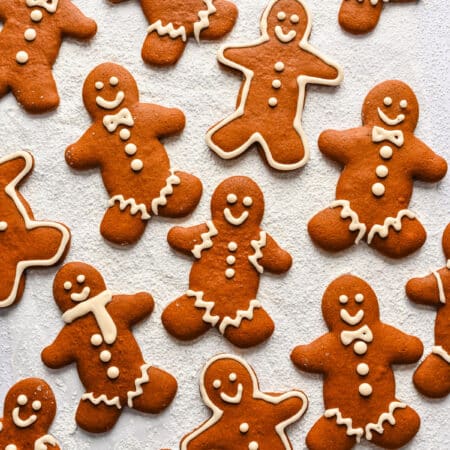 Several decorated no chill gingerbread men on a piece of parchment paper.