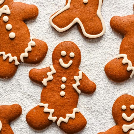 Decorated no chill gingerbread men on a powdered sugar background.