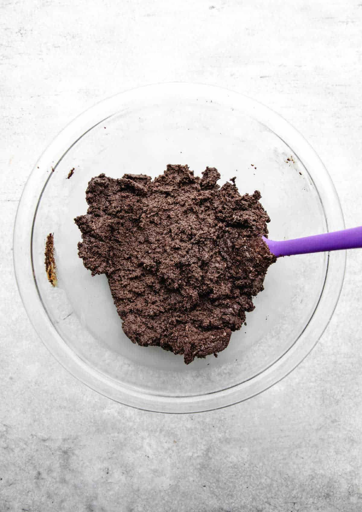 Peanut butter Oreo cookie ball filling in a glass mixing bowl. 