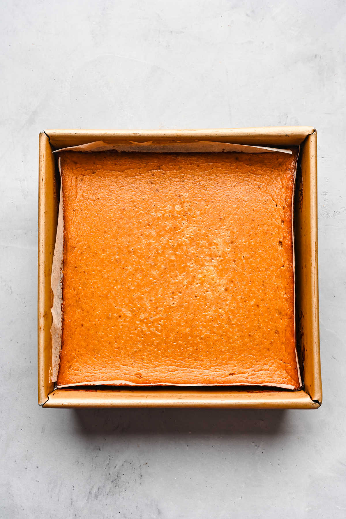 Baked pumpkin pie bars in a baking pan.