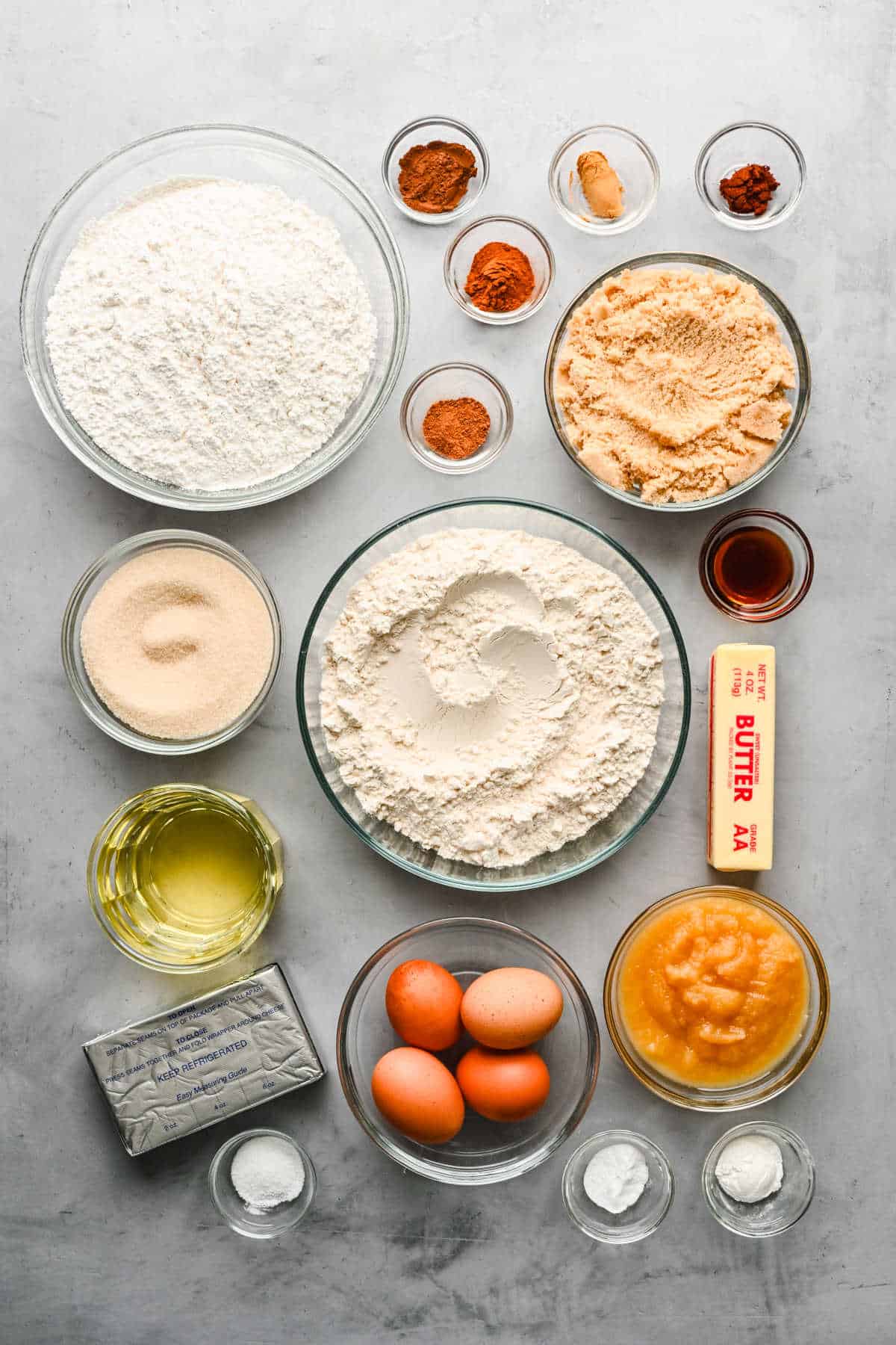 Ingredients for spice cake and cream cheese frosting in bowls and dishes.