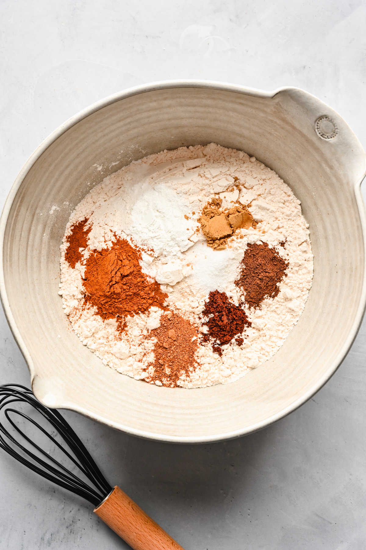 Dry ingredients for spice cake in a mixing bowl.