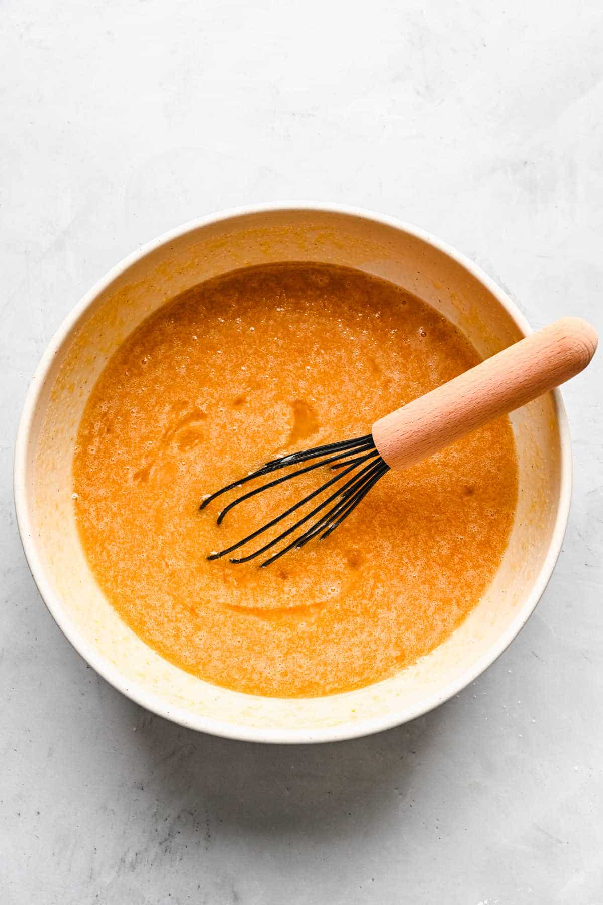 Wet ingredients for spice cake in a mixing bowl. 