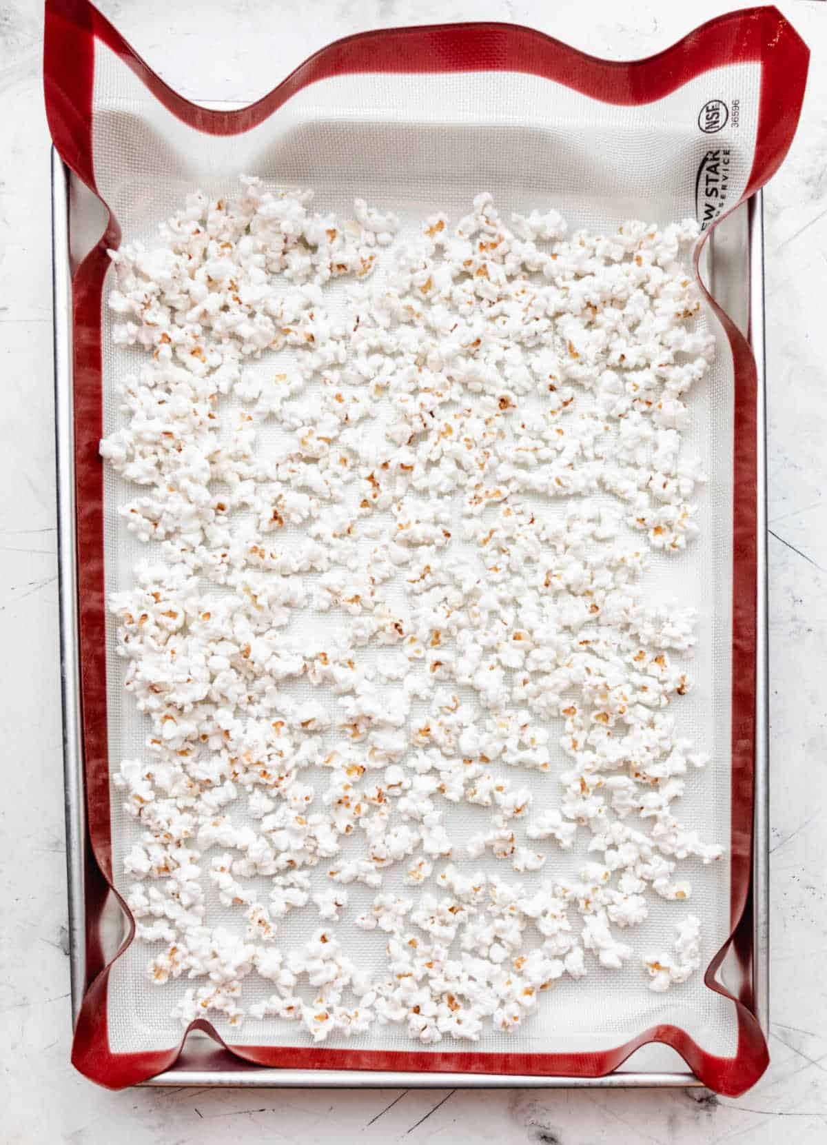 Popped popcorn on a baking sheet. 