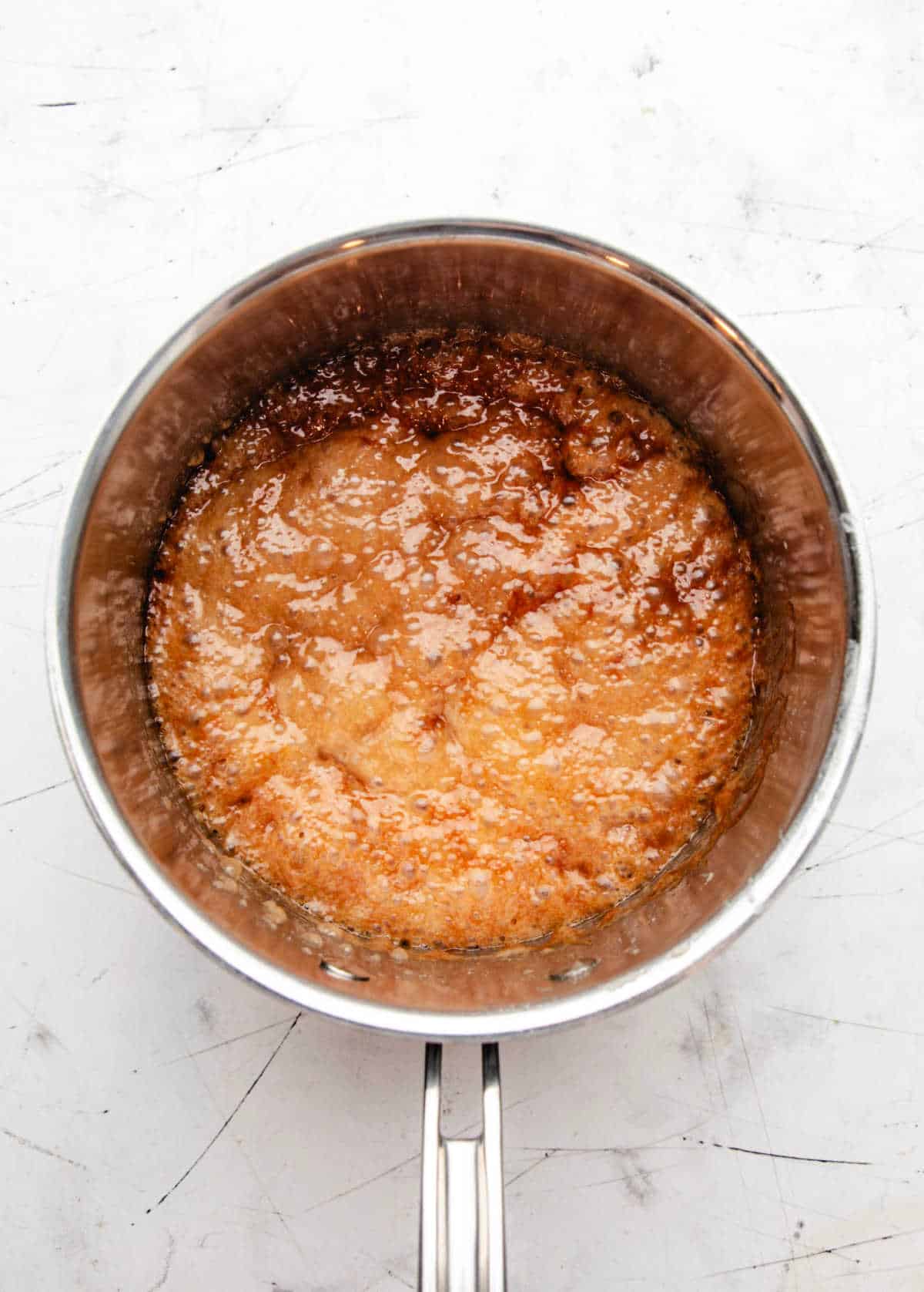 Boiling corn syrup and sugar mixture in a saucepan.