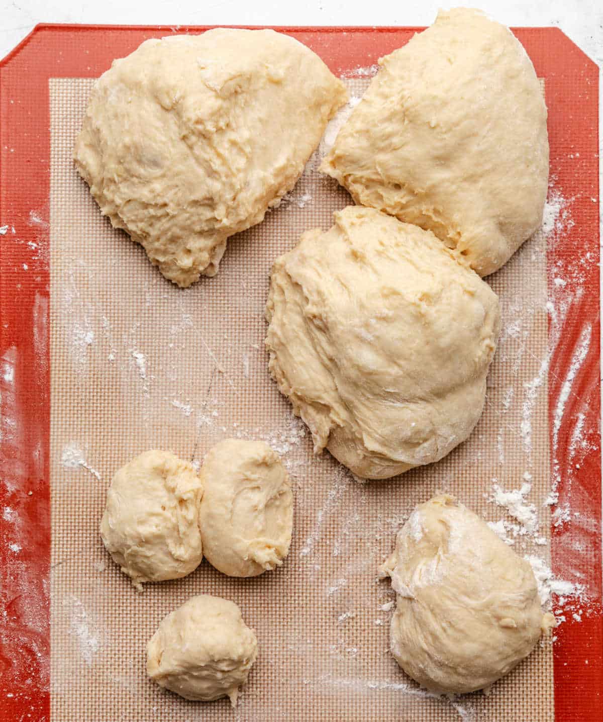 A piece of potato roll dough portioned into 3 pieces. 