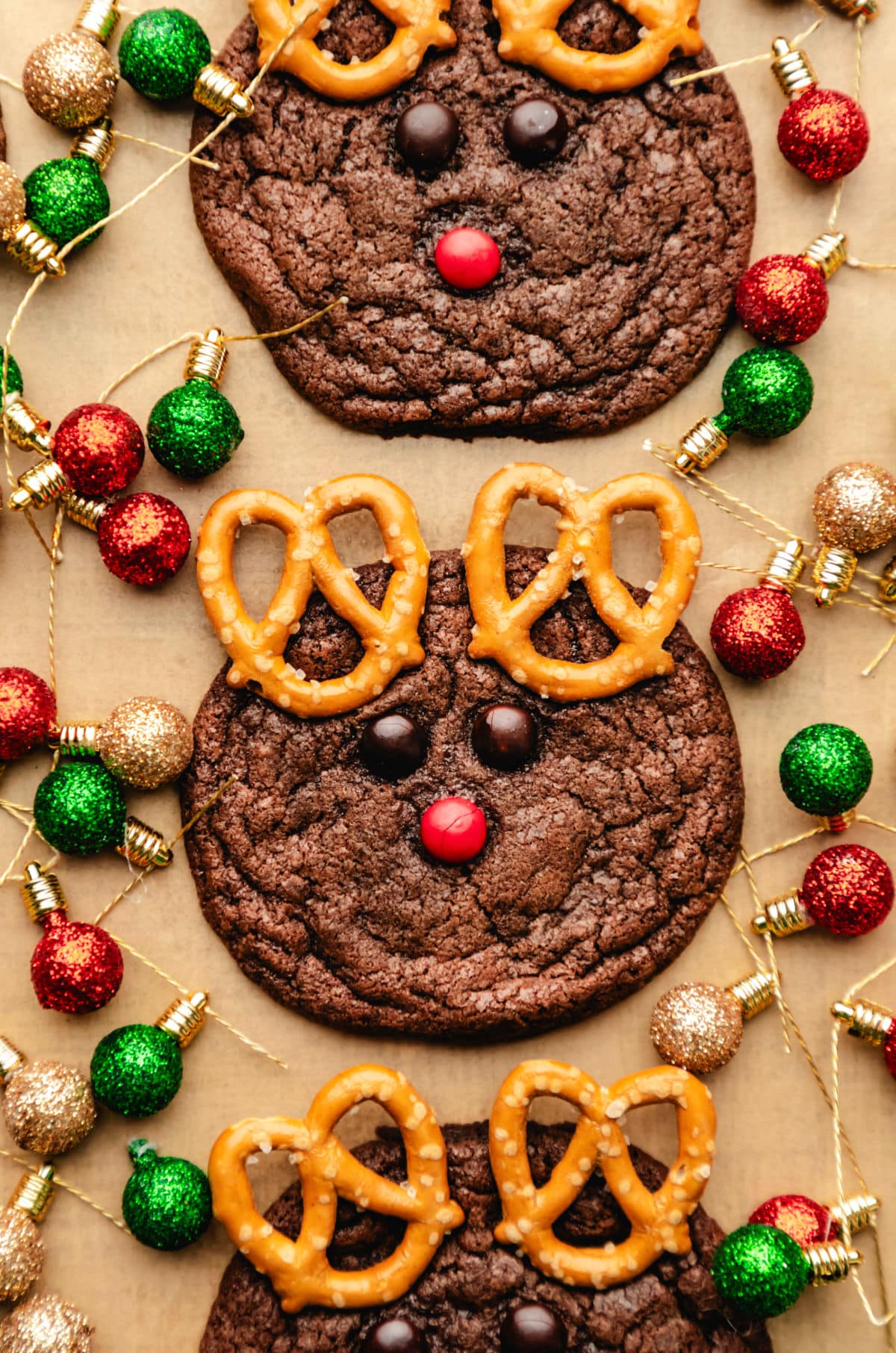 Reindeer Cookies Three reindeer cookies surrounded by Christmas light ornaments.