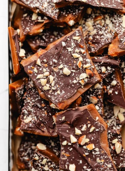 A pile of homemade toffee stacked on top each other.