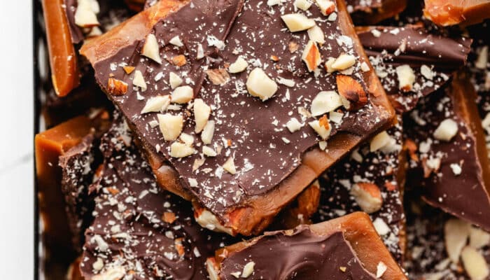 A pile of homemade toffee stacked on top each other.