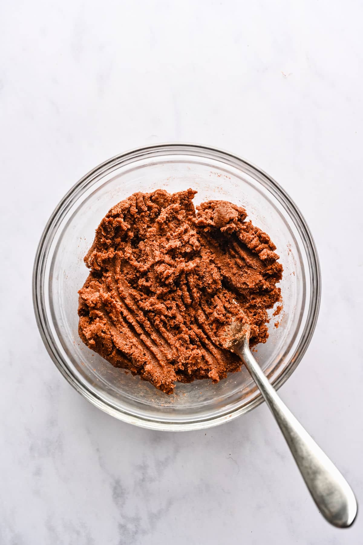 Braided cinnamon bread dough filling in a glass mixing bowl. 