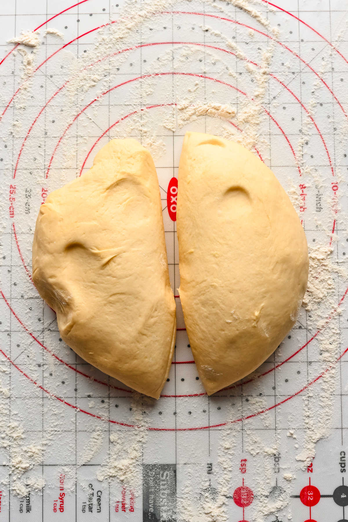 Braided cinnamon bread dough divided into to pieces. 