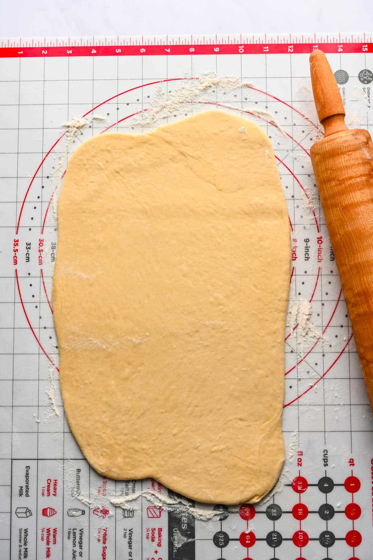 Braided cinnamon bread dough rolled out into a rectangle.