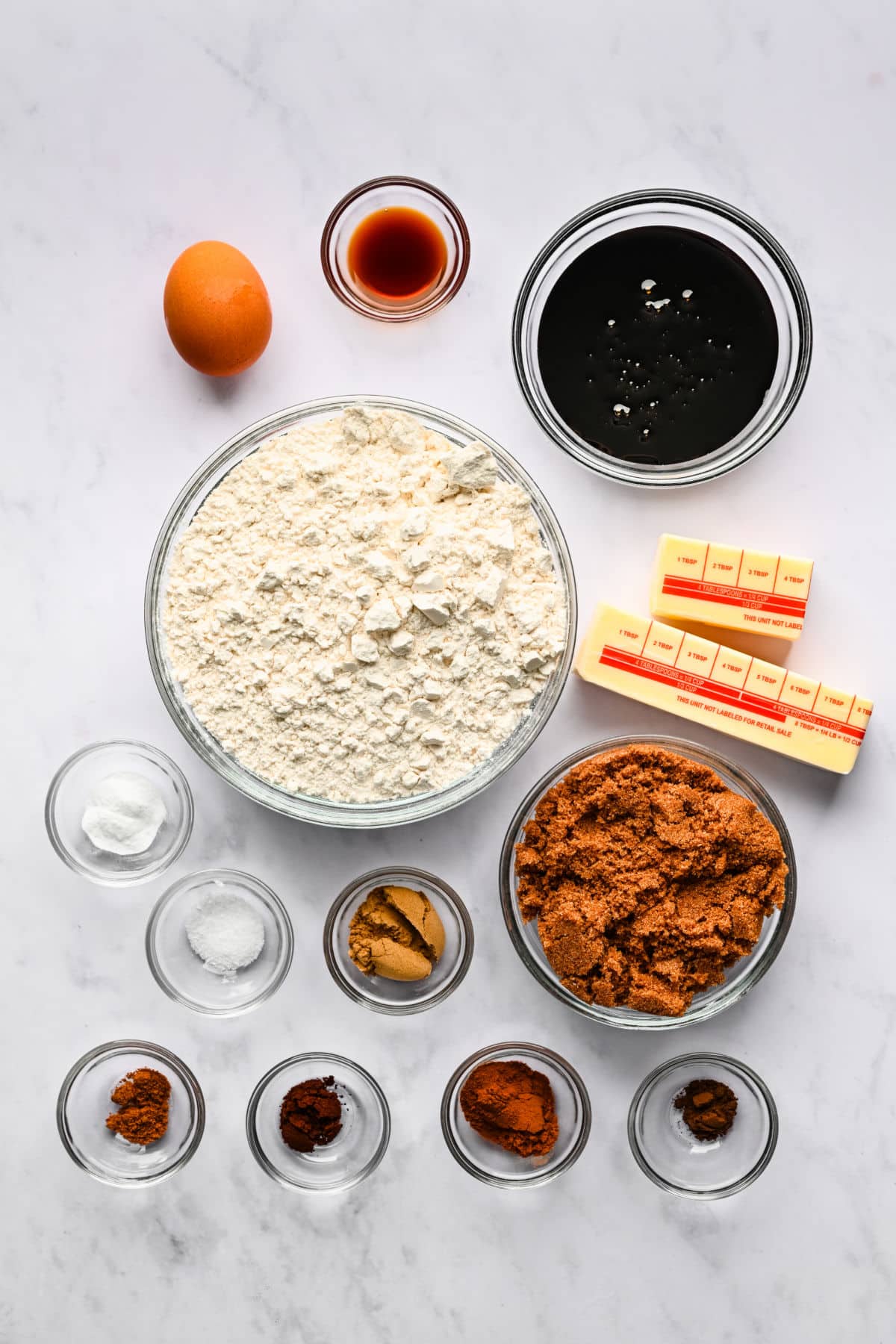 Ingredients for gingerbread men in glass dishes. 